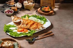 Deep fried crispy grouper fish with sambal dabu dabu photo