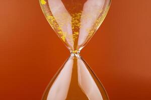 The hourglass indicates limited time and deadlines in which work is competing against the precious time in life. photo