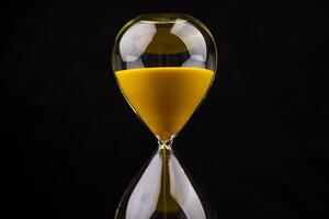 The hourglass indicates limited time and deadlines in which work is competing against the precious time in life. photo