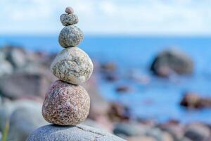 Pyramid of stones. Unstable balance of stone objects. Idyllic state of nature. photo