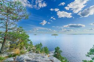 Beautiful stones and pine trees on the lake. Landscape of wild nature. photo
