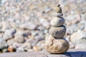 Pyramid of stones. Unstable balance of stone objects. Idyllic state of nature. photo