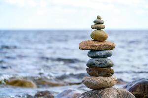 Pyramid of stones. Unstable balance of stone objects. Idyllic state of nature. photo