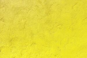 Texture of an old yellow plastered wall. Abstract construction background. photo
