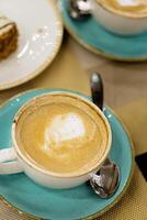 Cup of coffee latte art on a table photo