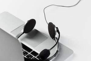call center support concept. headset on keyboard computer laptop photo