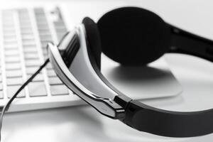call center support concept. headset on keyboard computer laptop photo