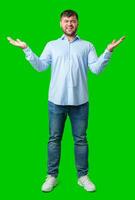 A man playfully posing with a quirky expression against a bright green background photo