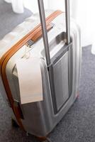 Close up of blank luggage tag label on a suitcase photo