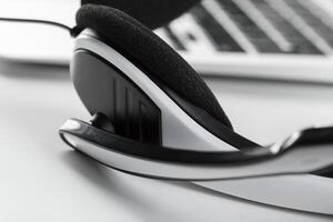 call center support concept. headset on keyboard computer laptop photo