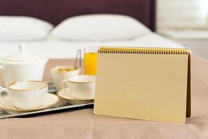 Two white mugs on a tray white bed, breakfast concept photo