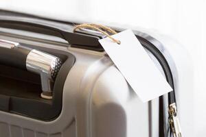 Close up of blank luggage tag label on a suitcase photo