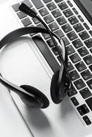 call center support concept. headset on keyboard computer laptop photo