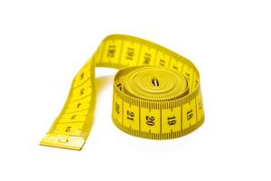 yellow metric measuring tape isolated on white panorama background photo