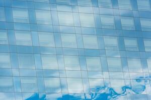 blue sky and clouds reflected in office building photo