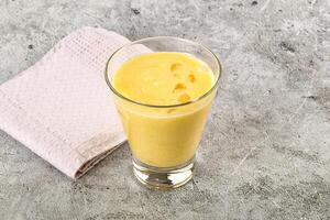 Cold sweet mango smoothie glass photo