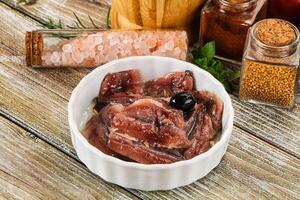 Canned anchovy with oil in the bowl photo