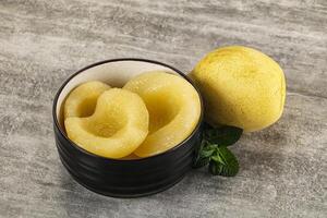 Canned yellow pear with syrup photo