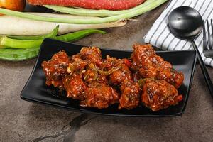 Manchurian chicken with sauce and spices photo