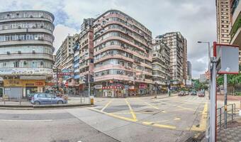 Dense urban architecture in Hong Kong with tightly packed high-rise buildings under a bright sky photo
