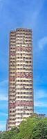 Dense urban architecture in Hong Kong with tightly packed high-rise buildings under a bright sky photo