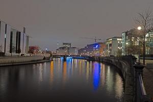 Night view of the Berlin government district with illuminated modern architecture reflected in the Spree photo