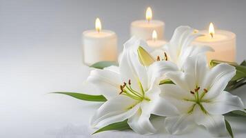 A solemn arrangement featuring a funeral lily and candles on a white background, with space for text, ideal for a memorial service announcement or tribute. photo