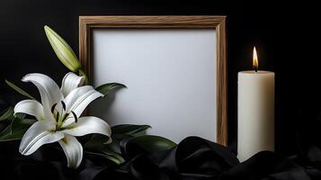 A black photo frame with a burning candle and a white lily on a table in a funeral home, symbolizing grief, remembrance, and honoring the departed.