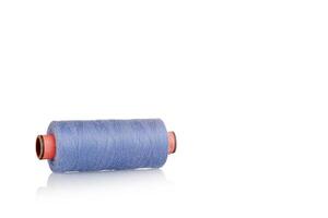 a skein of threads of blue color macro on a white background close up photo