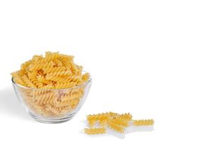 Pasta products in the form of a spiral on a plate, texture, on a white background photo