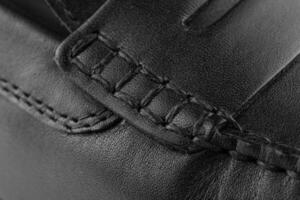 texture of black leather with thread stitching photo