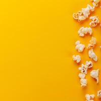 box with popcorn on a yellow background photo
