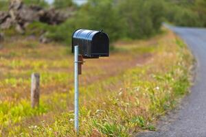 Old Weathered Mailbox at Rural Roadside in Iceland photo
