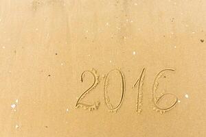 2016 Year written on the beach sand photo