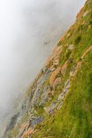 The Grossglockner mountains in foggy weather photo