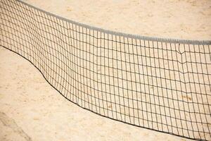 volleyball net on empty sand beach photo