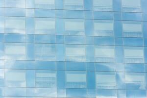 blue sky and clouds reflected in office building photo