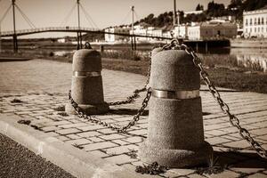 Stub posts linked in a chain on a quay photo