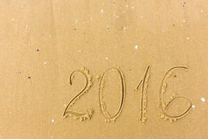2016 Year written on the beach sand photo
