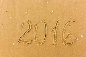 2016 Year written on the beach sand photo