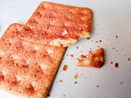 Biscuits flavoured with abon sapi or shredded beef, namely dried beef flakes, isolated on a white background. photo