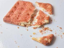 Biscuits flavoured with abon sapi or shredded beef, namely dried beef flakes, isolated on a white background. photo