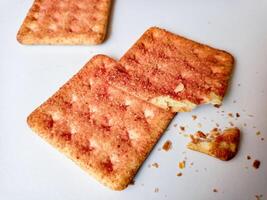 Biscuits flavoured with abon sapi or shredded beef, namely dried beef flakes, isolated on a white background. photo