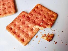 Biscuits flavoured with abon sapi or shredded beef, namely dried beef flakes, isolated on a white background. photo
