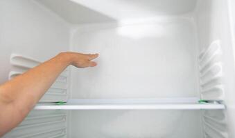 Ice and snow build up on the back wall of the refrigerator. Refrigerator failure, freon leak, temperature sensor defective, close-up photo