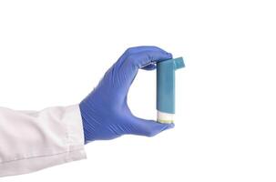 doctor's hand holds an inhaler from an attack of bronchial asthma on a white background, isolate. Concept of treatment and relief of seizures in lung diseases, asthmatic photo