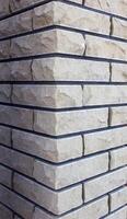 Modern brick column with brown and gray bricks, designer, texture, background, close-up, abstract photo