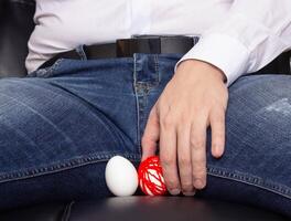 A man holds on to an egg in the scrotum. He has varicose veins of the spermatic cord, varicocele, problem, vein plexus photo