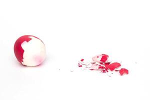 Red boiled easter egg with shell on white background, concept of the end of the holiday, traditions and customs for the celebration of Easter, isolate, Christ photo