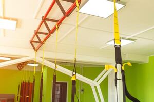 Modern new gym in the fitness center to practice a new sport of the TRX loop, metabolic photo